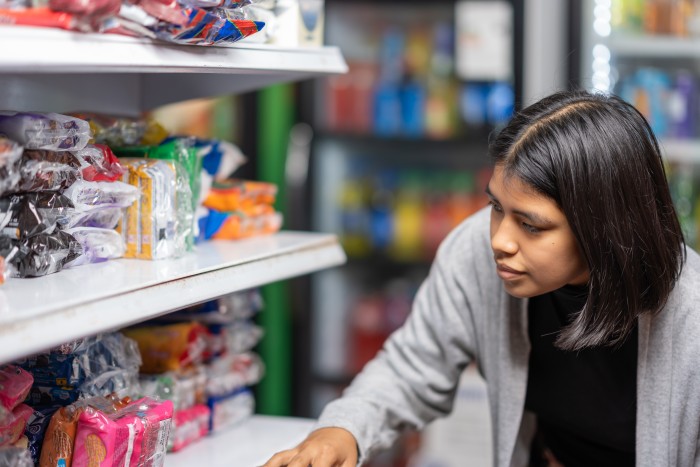 young-woman-buying-products-in-a-supermarket-2023-